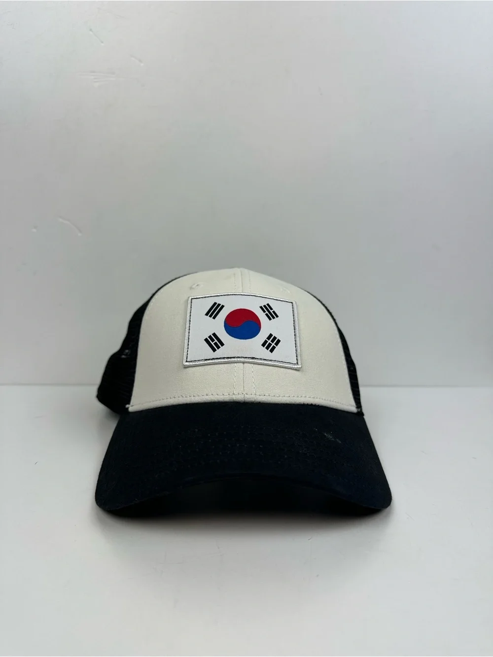 The North Face Black & White Trucker Hat with South Korea Flag Patch